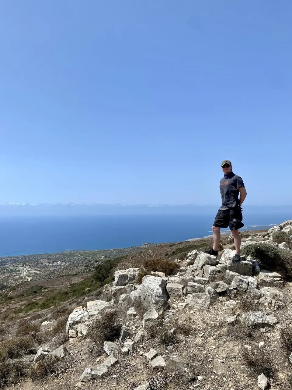 Jan standing on a rocky hilltop above the sea